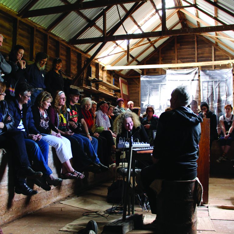 performance from the 2019 Ten Days' festival of our Acoustic Life of Sheds where a crowd watches on a performance within a barn setting