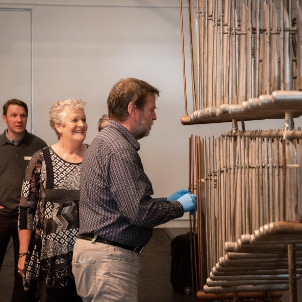 Mary Tilley, the granddaughter of Elsie Corrick, the youngest member of The Marvellous Corricks watches percussionist Bruce Innocent learning to play the original Marvellous Corricks Organ Chimes at QVMAG.