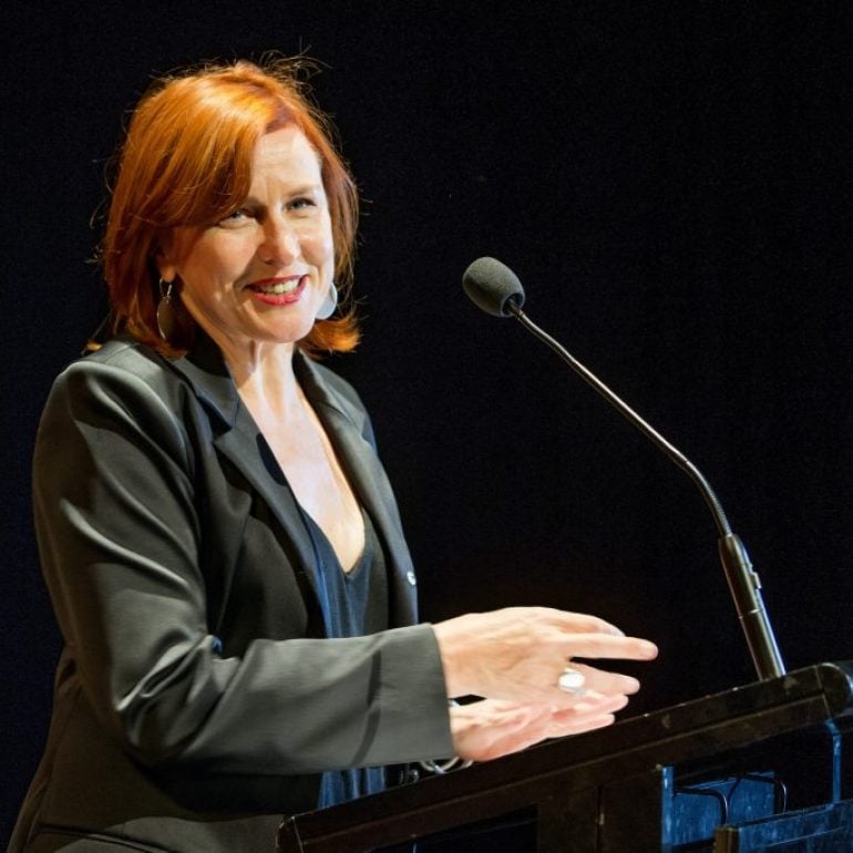 Artistic Director Lindy Hume giving a talk in front of a lectern.