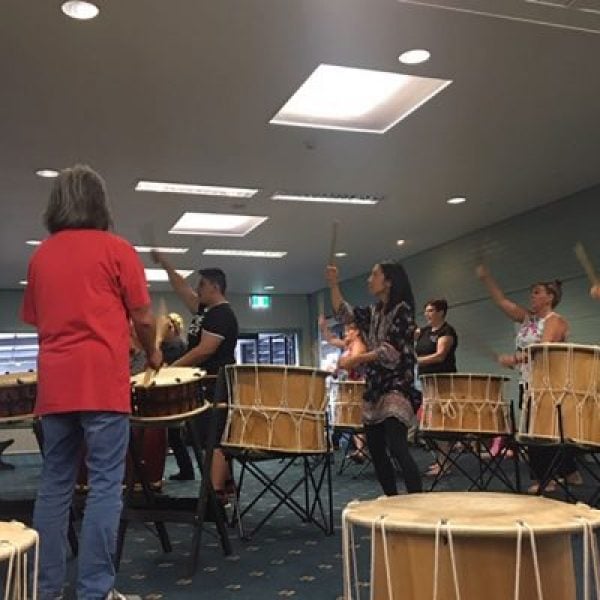 A group of Taiko drummers practice in a music room ahead of their mapali performance