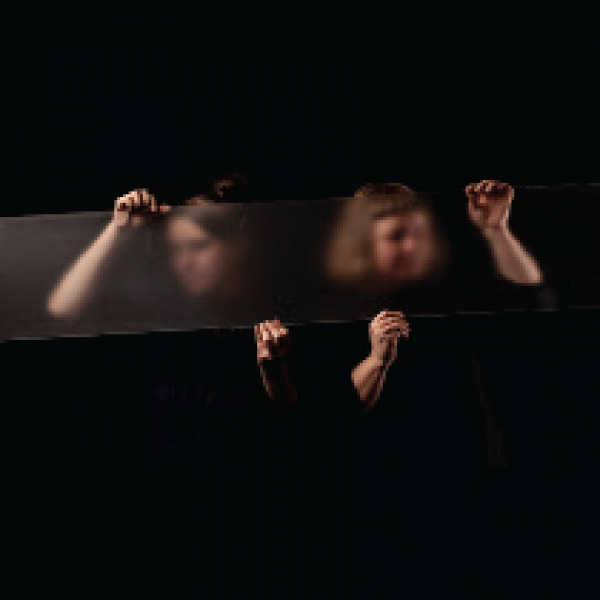 two women behind a pane of glass