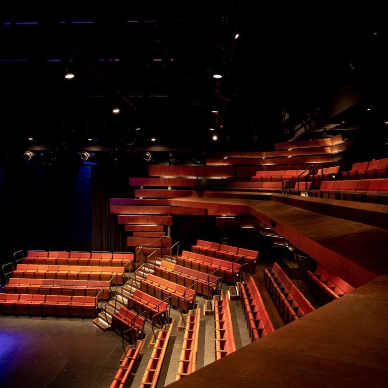 Studio Theatre at The Theatre Royal, we see stairs under stage lighting and the black stage floor at the bottom