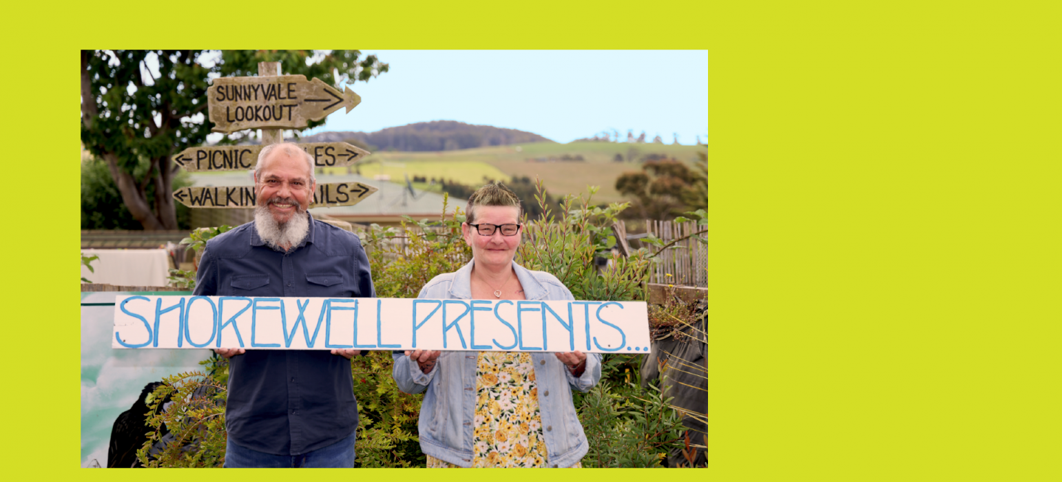 Shorewell Presents hero image, Two smiling people hold a hand-painted sign reading 'SHOREWELL PRESENTS...'